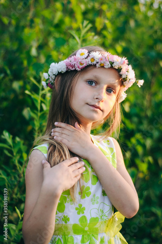girl with long hair and a wreath of flowers on her head