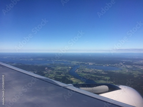 View from the plane window on the Norwegian lakes and fields