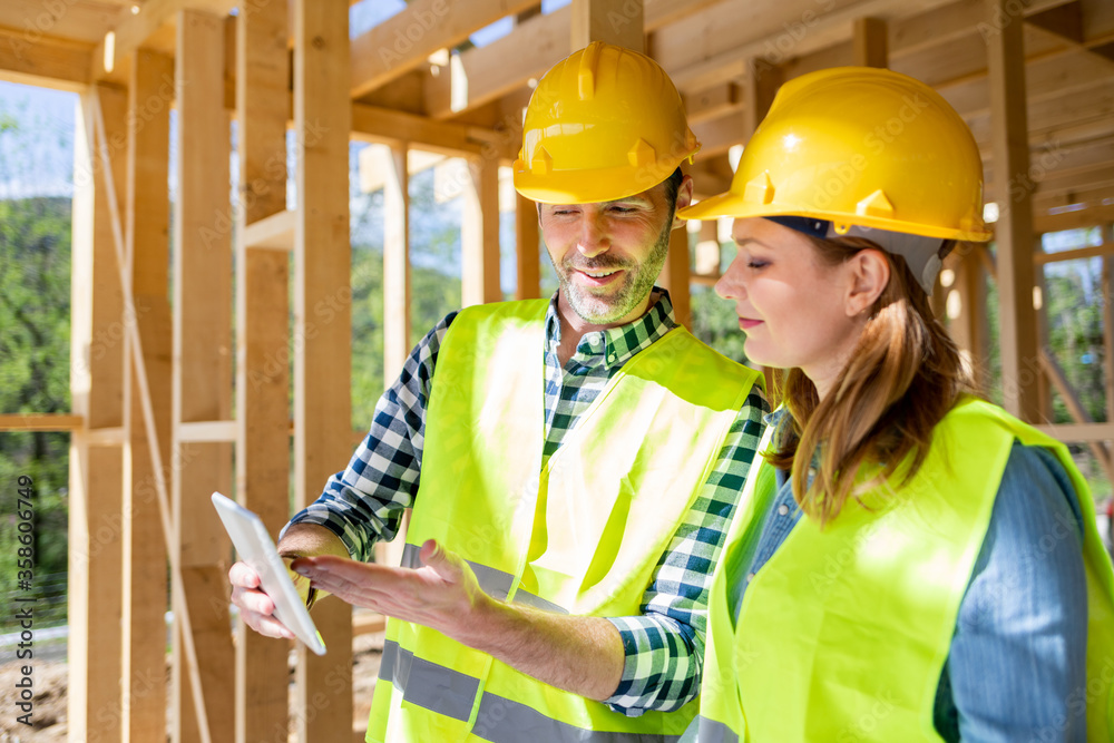 Team engineer and architect are meeting to plan for new project of wood frame house on building site Team engineer and architect are meeting to plan for new project of wood frame house on building site