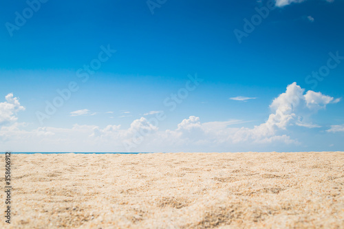 Fototapeta Naklejka Na Ścianę i Meble -  View of empty tropical sand beach with puffy white cloud and blue sky background