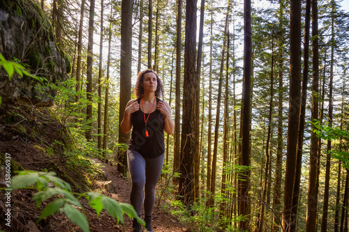 Adventurous Girl Hiking in a Green and Vibrant Rain Forest during a sunny spring day. Taken in Abbotsford, East of Vancouver, British Columbia, Canada. Nature Background Panorama © edb3_16