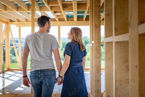 Loving couple at construction site of their new home dreams come true