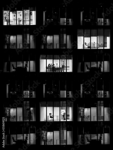 Black and white photo of office buiilding at night time