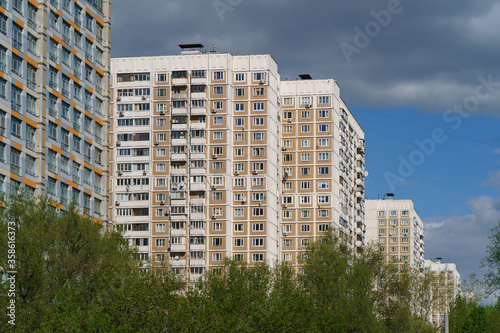 Moscow cityscape in summer day. White and gray clouds over the residential buildings in the sky. Modern buildings. Concepts of lifestyle and beauty of nature. Telephoto lens.