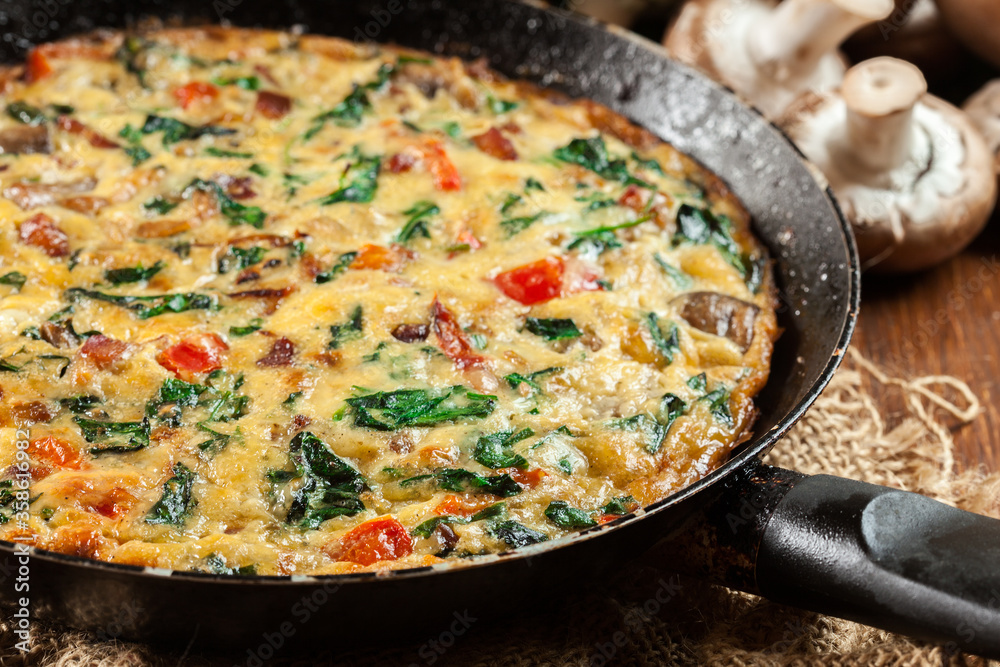Frittata made of eggs, mushrooms and spinach Frittata made of eggs, mushrooms and spinach