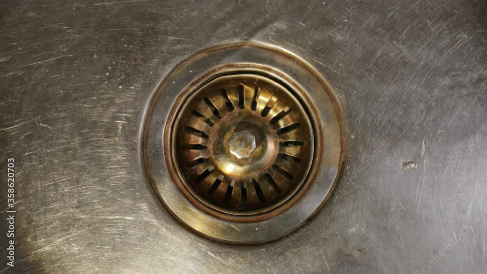 Releasing the water from kitchen basin unplugging the drain plug Releasing the water from kitchen basin unplugging the drain plug