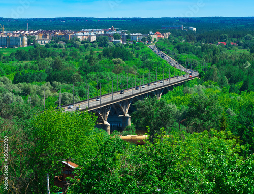 Diagonal highway bridge in green woods background