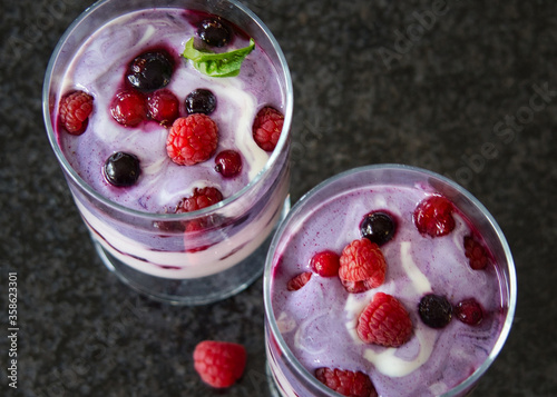 Joghurt, Pudding Dessert, Nachtisch im Glas mit Früchten, Beeren und einem Minzblatt