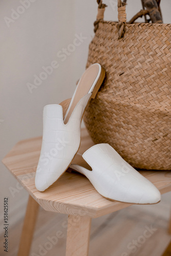 beautiful women's shoes on legs and layouts, leather white mules and loafers, in the interior of a room or office, a girl shoes, blue skirt and white shoes, a noble and elegant style, modern and trend