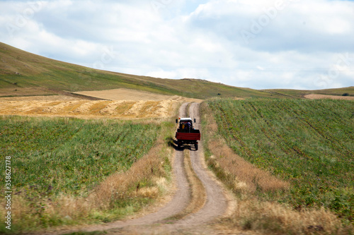 A tractor driving across farmlands