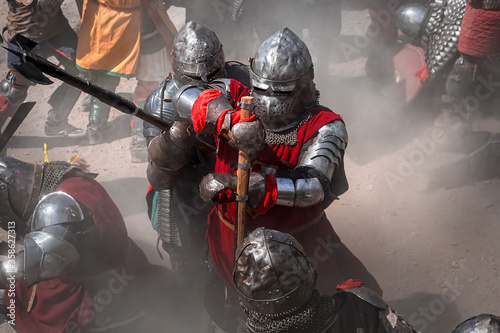 Dekoracja na wymiar  warriors-in-knight-armor-fighting-on-battlefield-reenactment-of-medieval-war