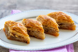 Turkish national delight baklava with walnuts and honey on a white wooden background. Traditional eastern dessert.