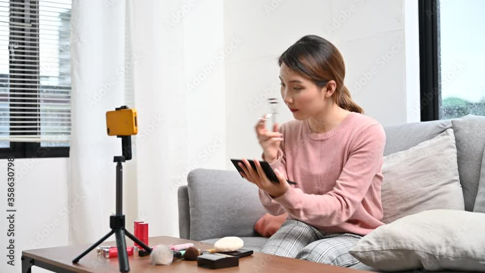 Asian woman blogger live steam video of makeup cosmetic at home online influencer on social media concept
Asian woman blogger live steam video of makeup cosmetic at home online influencer on social media concept