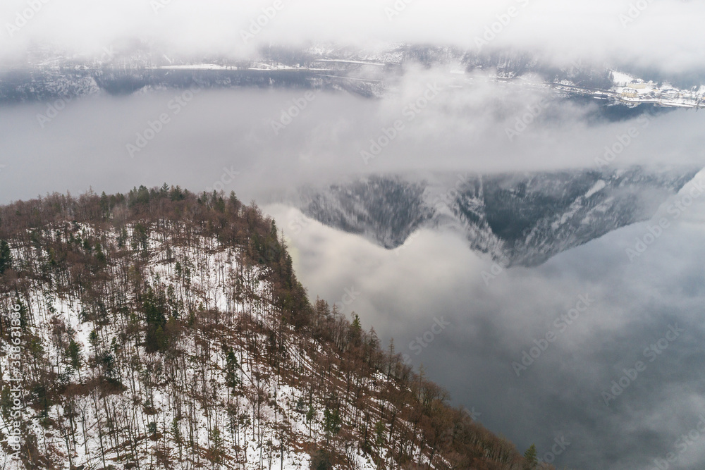 Obraz premium Aerial drone view of foggy Obertraun mountains Hallstatt in Salzkammergut, Austria in Winter