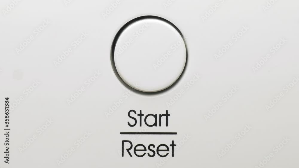 Finger presses start reset button on a dishwasher macro