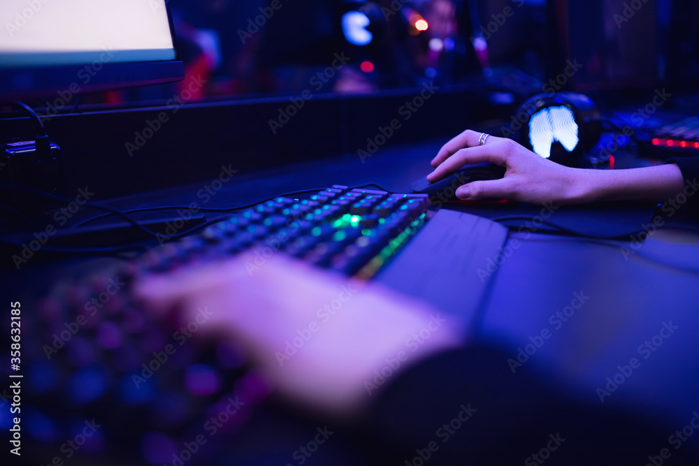 Professional online gamer hand fingers mechanical keyboard in neon color blur background. Soft focus, back view Stock Photo | Adobe Stock Professional online gamer hand fingers mechanical keyboard in neon color blur background. Soft focus, back view Stock Photo | Adobe Stock