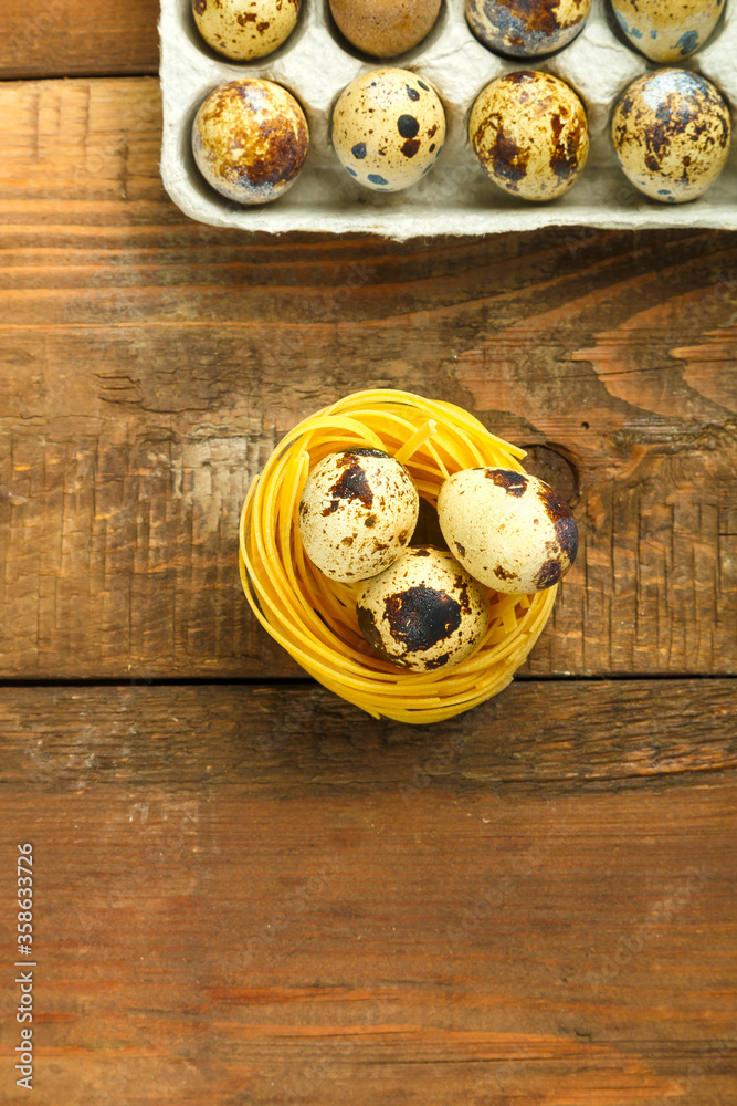 pasta nests on the table in which quail eggs lie. pasta nests on the table in which quail eggs lie.