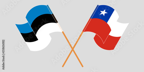 Crossed and waving flags of Chile and Estonia
