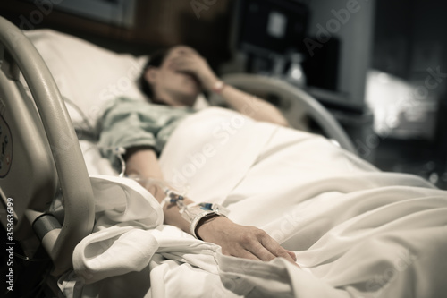 Sick woman lying in hospital bed. 