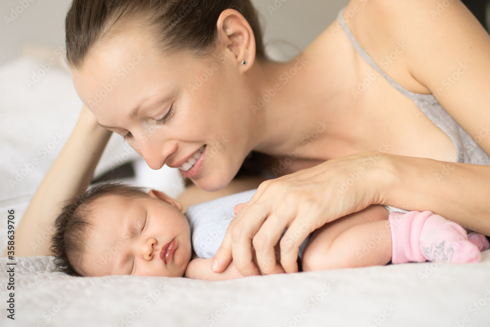 Portrait of happy smiling mother and her new born baby girl Portrait of happy smiling mother and her new born baby girl