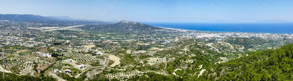 Incredible panoramic view from Mount Filerimos. Rhodes Island, Greece. Beautiful scenery at sunny summer day. .Landscape with sea shore and the airport at the horizon