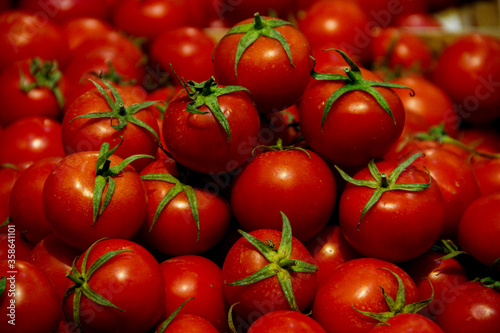 Fresh cherry tomatoes with green leaves