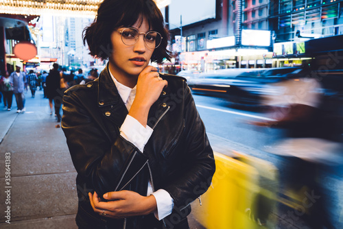 Bilde på lerret Half length portrait of stylish hipster girl in cool eyeglasses standing outdoor
