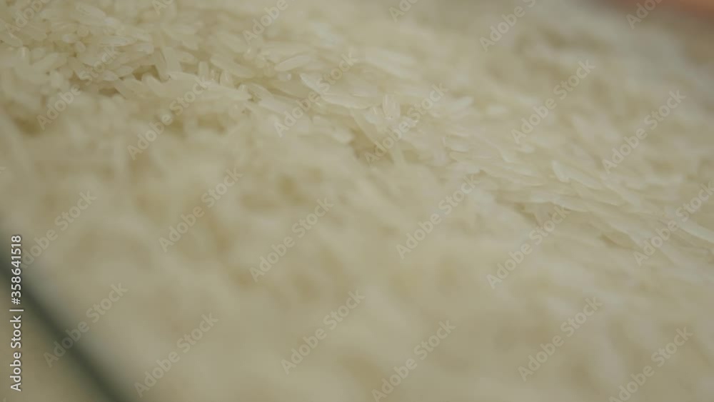 Extreme close-up of white long-grain rice on supermarket shelf. Raw edible food selling in grocery. Healthy protein ingredient, healthful diet. S-log 2. Extreme close-up of white long-grain rice on supermarket shelf. Raw edible food selling in grocery. Healthy protein ingredient, healthful diet. S-log 2.