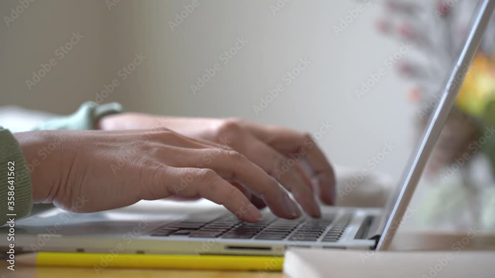 Business asian woman using laptop computer at desk, Female hands typing on notebook with keyboard working at home
