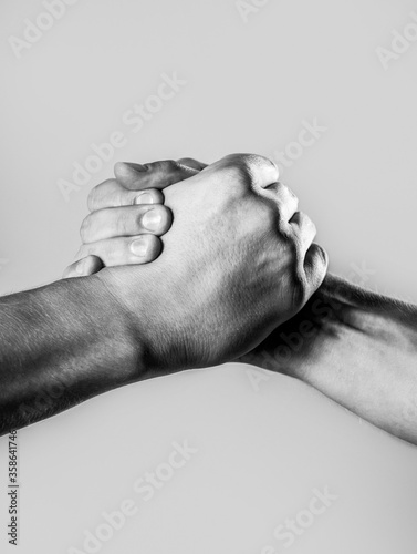 Two hands, isolated arm, helping hand of a friend. Handshake, arms. Friendly handshake, friends greeting. Male hand united in handshake. Black and white