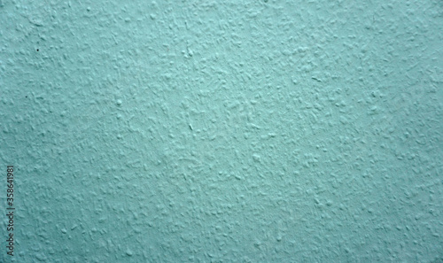 Close-up of a turquoise colored ingrain wallpaper.