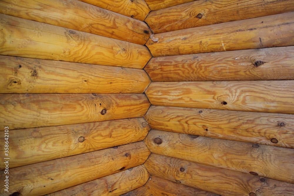 Clear angle in modern wooden house hewn logs construction, russian style country building interior fragment close up on a sunny summer day Clear angle in modern wooden house hewn logs construction, russian style country building interior fragment close up on a sunny summer day