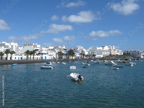 Charco de San Ginés - blue lagoon surrounded by white houses under blue sky, Arrecife, Lanzarote, Canary Islands, Spain