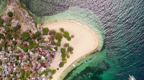 Philippines Tulang Diot island top view of beach area with Bangka boats, Aerial top view lowering shot photo