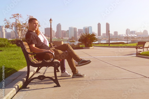Couple relaxing on City bench.