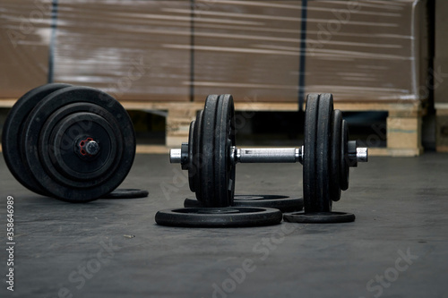 Dumbbells prepared for training in a warehouse. © Trepalio