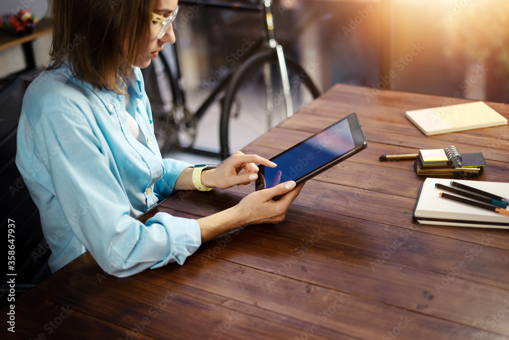 © Rymden - Woman pointing on digital tablet screen, chatting in social networks, meeting website, searching internet, sending sms, using text messenger or online banking. Close up photo
