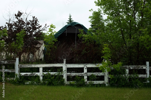 white painted fence with barn