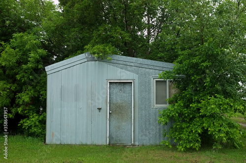 old wooden door shed with green trees