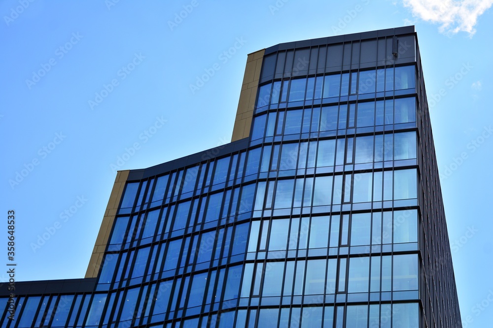 Facade texture of a glass mirrored office building. Fragment of the facade. Modern architecture of the office building. Facade texture of a glass mirrored office building. Fragment of the facade. Modern architecture of the office building.