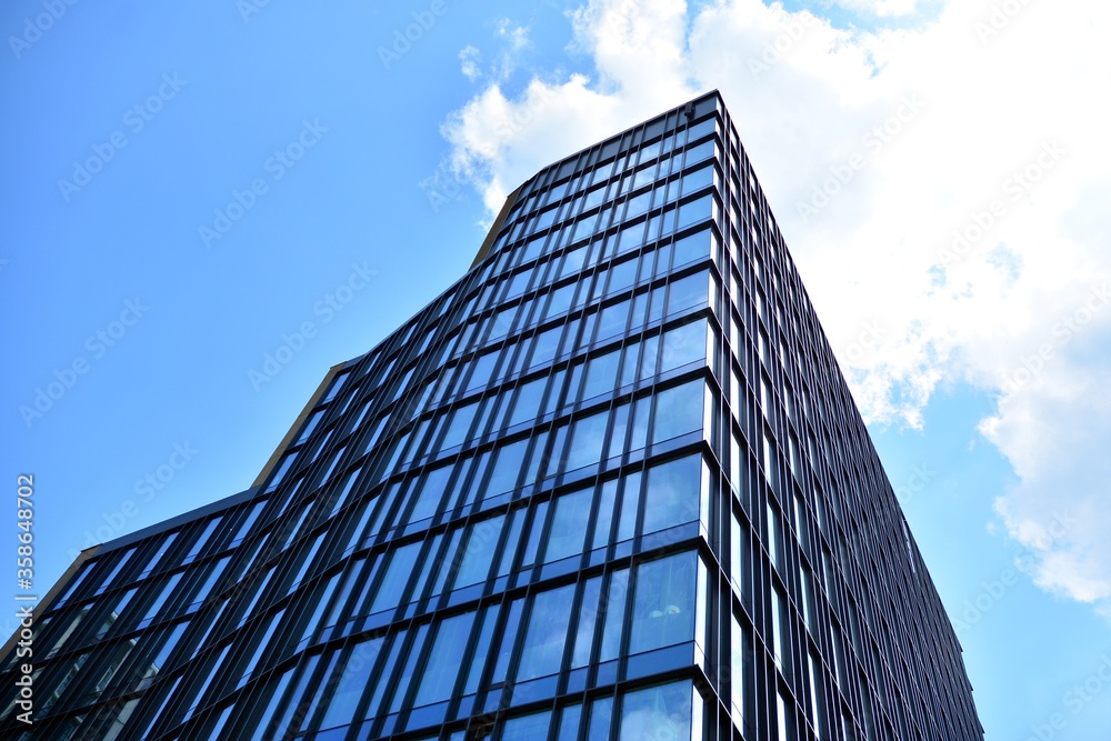 Facade texture of a glass mirrored office building. Fragment of the facade. Modern architecture of the office building. Facade texture of a glass mirrored office building. Fragment of the facade. Modern architecture of the office building.