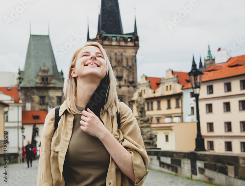 Photography girl removes mask from face on the street of Prague after the pandemic