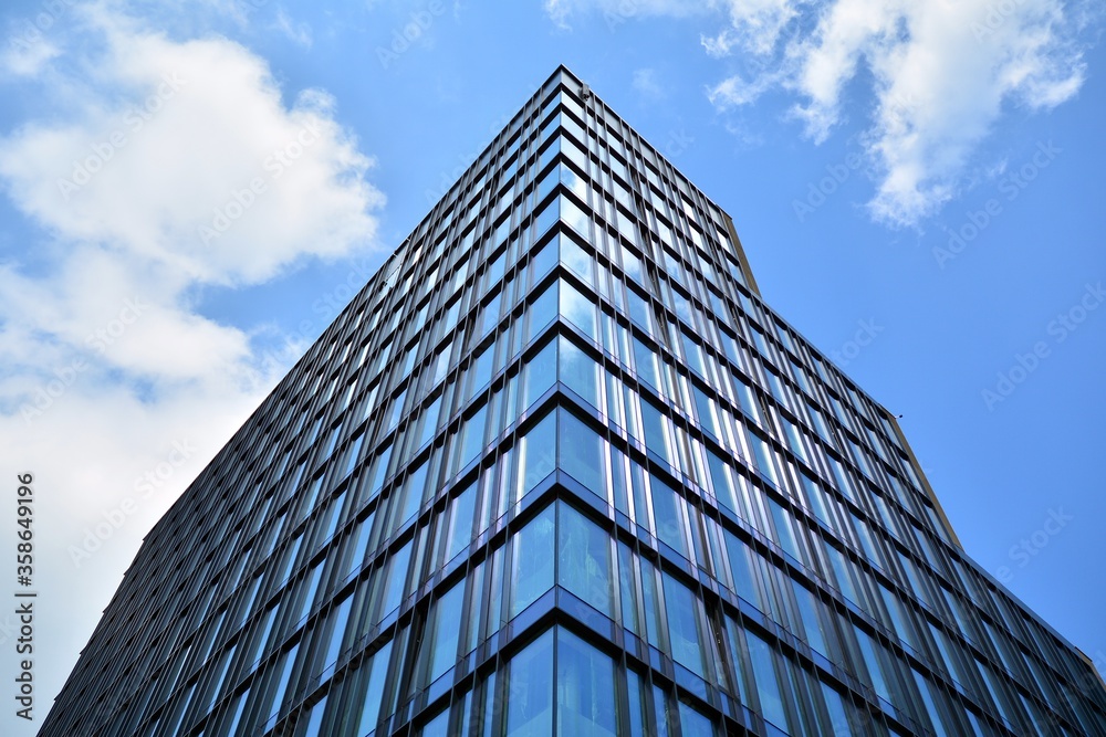 Facade texture of a glass mirrored office building. Fragment of the facade. Modern architecture of the office building.