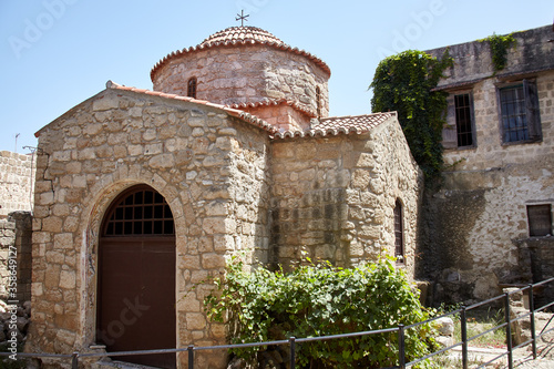 Small typical greek Chapel. Small building of Christian church on sunny day in ancient coastal town