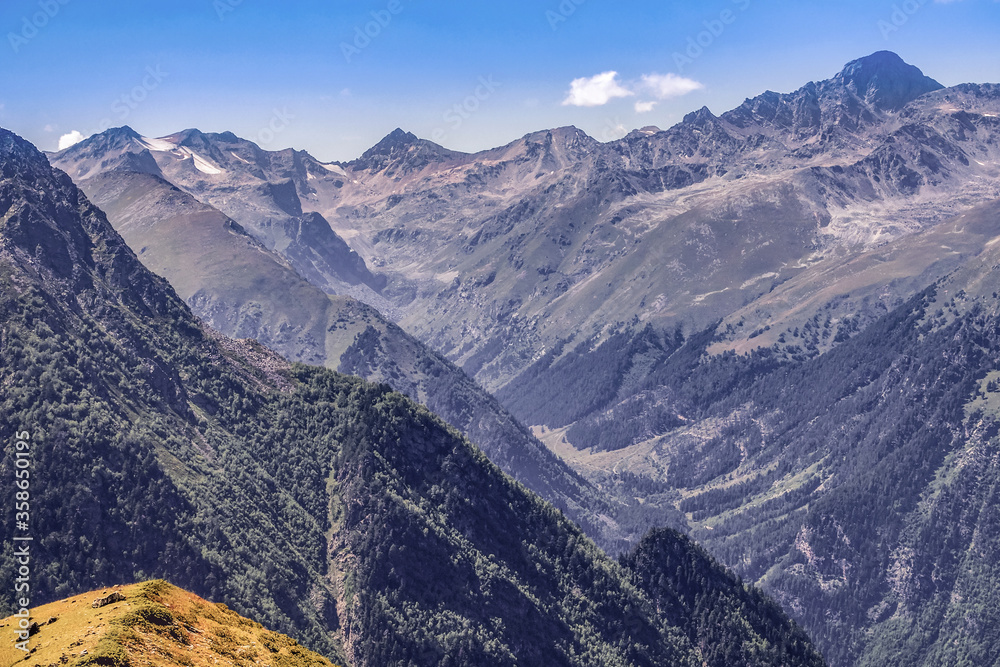 Picturesque mountain scenery with cumulus clouds. Wildlife. Hiking. Daytime. precipice