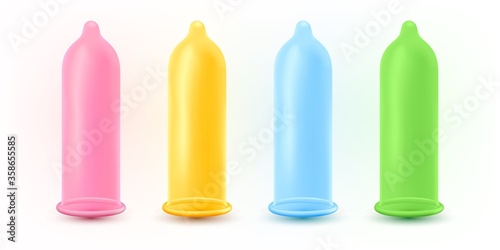 Set of colorful condoms over light background.