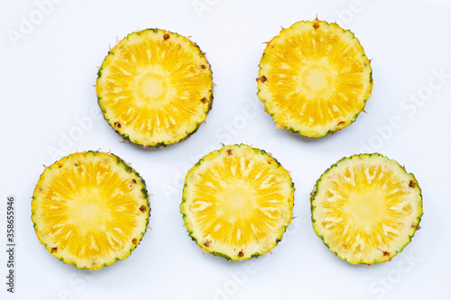 Fresh pineapple slices on white background.