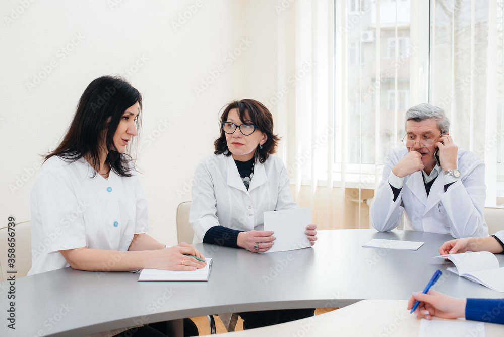 Meeting of doctors in the clinic about the virus epidemic. Virus, and epidemic, quarantine Meeting of doctors in the clinic about the virus epidemic. Virus, and epidemic, quarantine