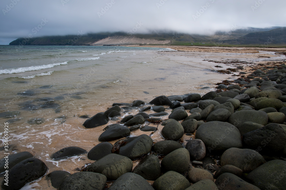 black pebbles on sandy beach iceland west fjords black pebbles on sandy beach iceland west fjords