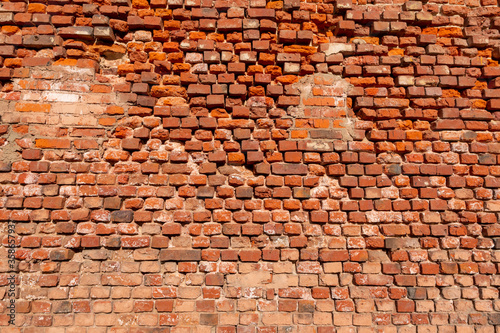 Old red brick wall background. Traditional building exterior. Aged and grunge facade. 